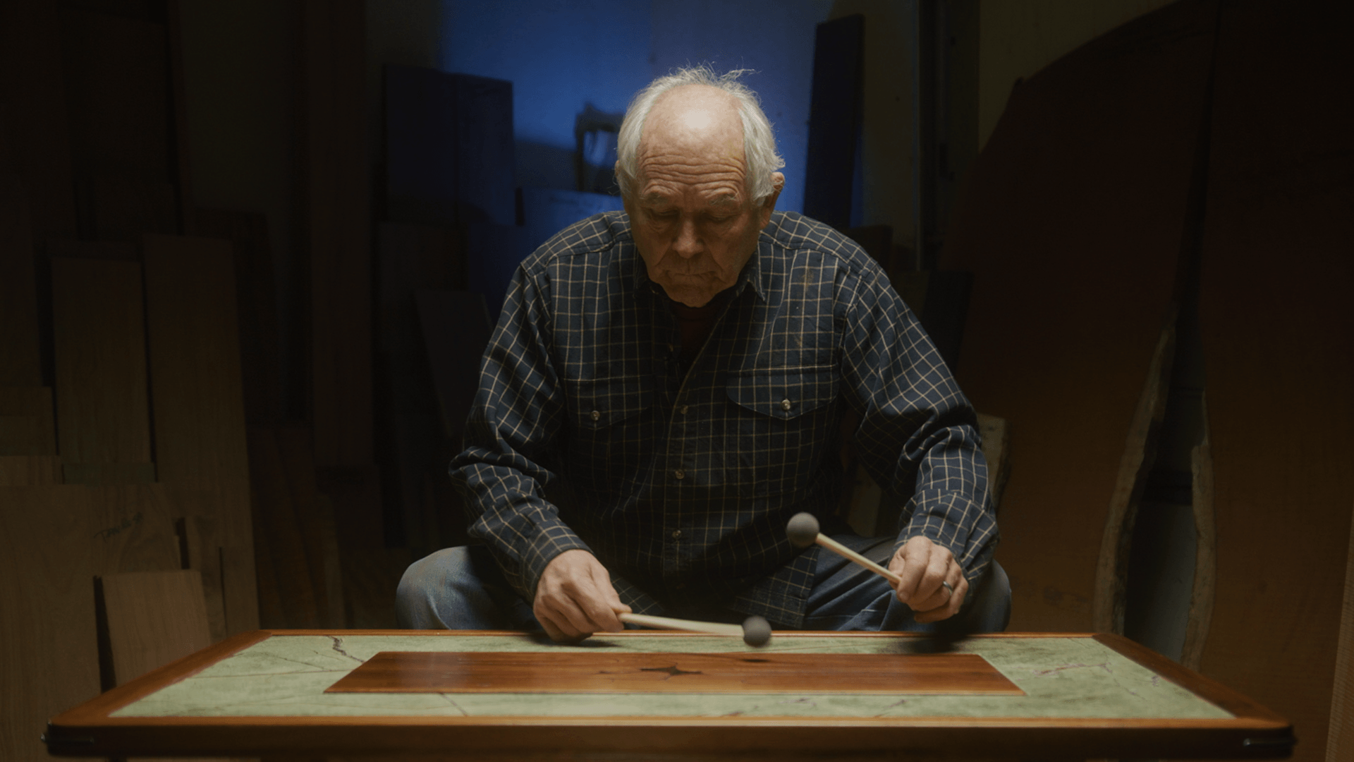 Craftsman playing a handcrafted Hardwood Music Company wooden drum