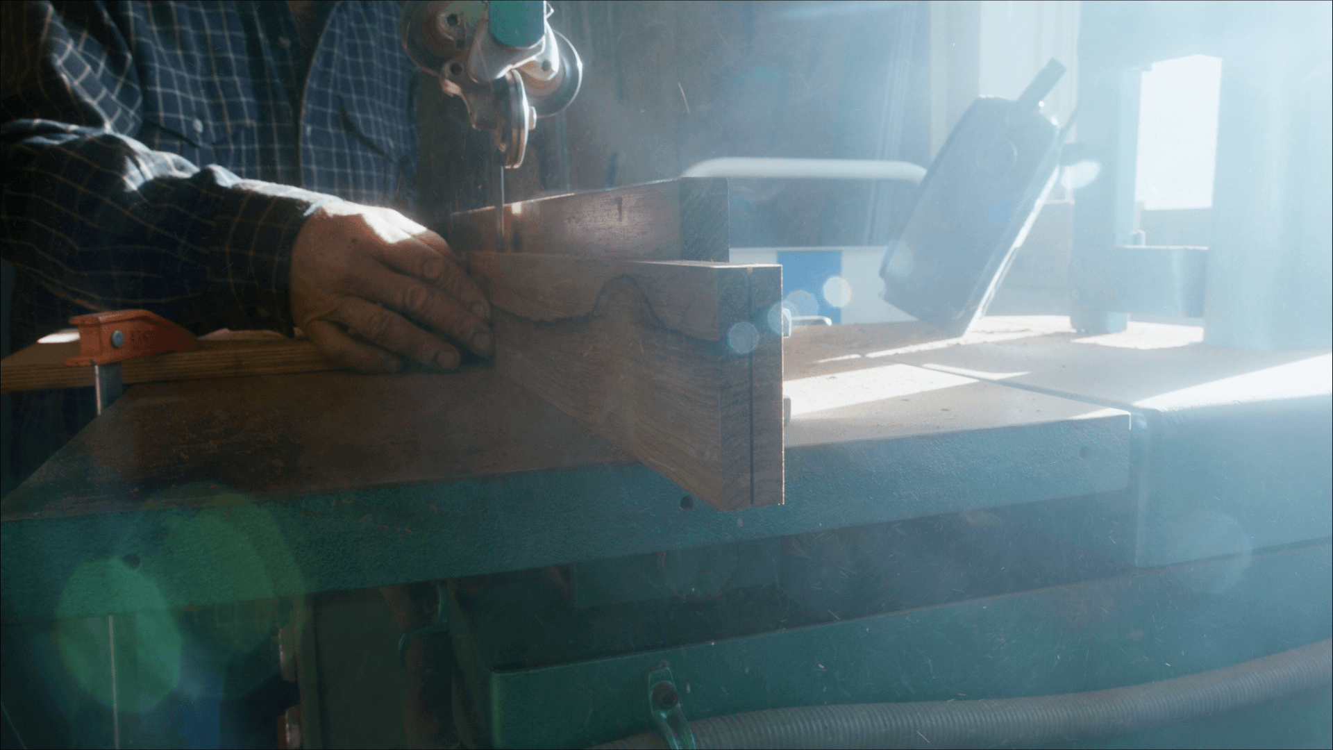 Scroll saw cutting the tongue design into a wooden percussion instrument